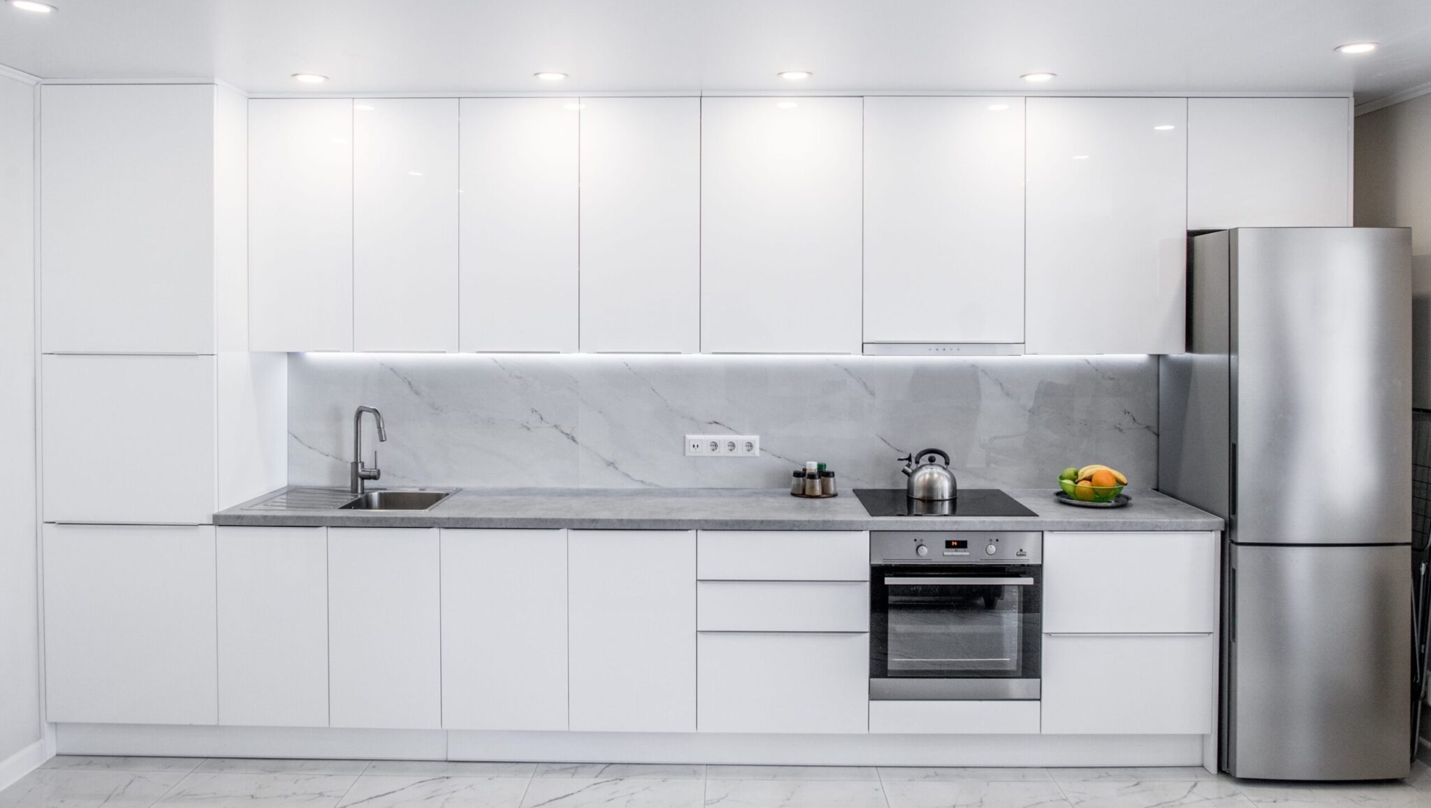 Front,View,Of,A,Modern,White,Kitchen,With,Many,Cabinets
